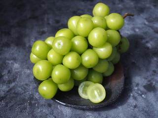 Japanese green grapes or shine muscat grape fruits on grey color background.