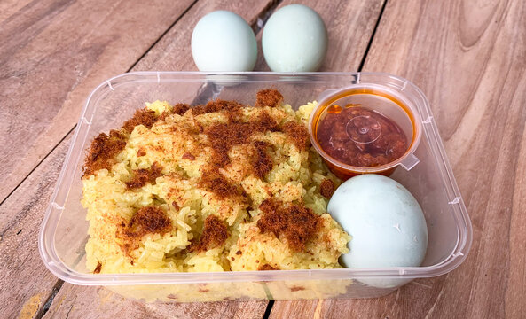 Yellow sticky rice with fish floss topping, spicy sambal and salted egg.