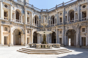 Fototapeta na wymiar View at the Renaissance main cloister, with ornamented fountain in the middle, an iconic piece of the Portuguese renaissance type, on Convent of Christ, Tomar