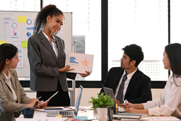 Confident female executive manager giving presentation, convincing business partners on negotiations at marketing workshop