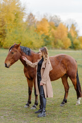 Naklejka na ściany i meble Woman on a horse at rancho. Horse riding, hobby time. Concept of animals and human