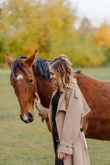 Fototapeta premium Woman on a horse at rancho. Horse riding, hobby time. Concept of animals and human