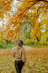 Woman walking in the autumn park, a healthy lifestyle, walk, exercise