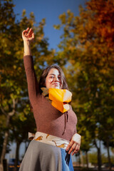 Outdoor fashion portrait of young Latin American woman posing in park