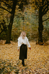 Woman walking in the autumn park, a healthy lifestyle, walk, exercise