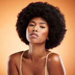 Skincare, portrait and black woman with face makeup against an orange studio background. Young,...