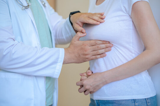 Experienced healthcare worker performing the breast examination