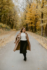 Fototapeta premium Woman walking in the autumn park, a healthy lifestyle, walk, exercise