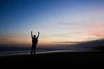 the silhouette of a person holding a finger