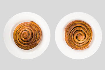 Cinnamon buns on a plate isolated on light gray background. Top view.
