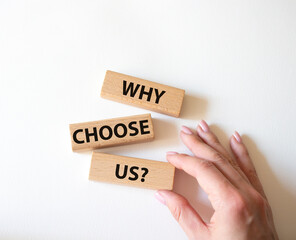 Why choose us symbol. Concept words Why choose us on wooden blocks. Beautiful white background....