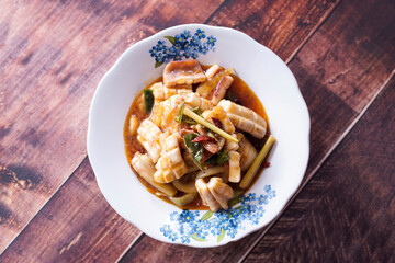 Sweet and sour squid for food menu photos in a restaurant with a wooden background