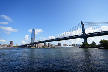 Fototapeta na wymiar New York City, New York USA - September 2022. Manhattan bridge. Iron bridge view. Historic New York place. Brick wall buildings. Brownstone building.