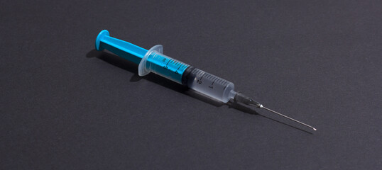 Disposable plastic syringe prepared for injection and vaccination in the hospital. The concept of medicine and health