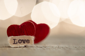 Valentine's Day greetings concept. Little red wooden heart and text Love close up. Valentines...