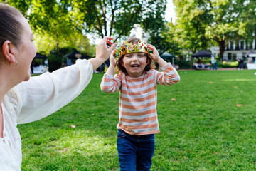 Mother and daughter playing with a gold crown.