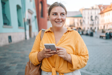 Fototapeta premium Close up of women's hands holding cell telephone with blank copy space scree for your advertising text message or promotional content, hipster girl watching video on mobile phone during coffee break