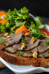 Sourdough sandwich, oyster mushroom and tenderloin slices with seasonal vegetables