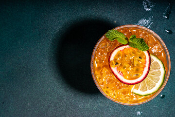 Passion fruit martini cocktail. Sweet pornstar alcoholic drink with fresh passion fruit and lime, with bar utensils copy space