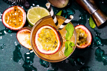Sweet colorful tropical cocktail with passion fruit, lime and mint. Long boozy alcohol passion...