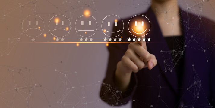 Famale finger touching on satisfiction icon for survey and review customer feeback with blurred woman background.
