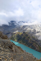 Limmerensee reservoir surrounded by Muttenchopf mountain and Muttsee mountain lake in Glarus, Switzerland