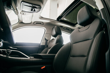Obraz na płótnie Canvas Luxury car inside. Interior of prestige modern car. Black perforated leather seats