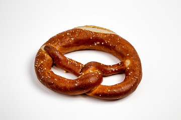 Side View of German pretzel with salt isolated on white background.
