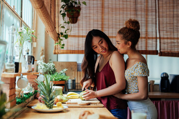 Lesbian couple in the kitchen while making breakfast