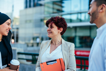 Urban coworkers talking in street