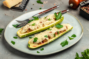 Zucchini boats with cheese and minced. Food recipe background. Close up