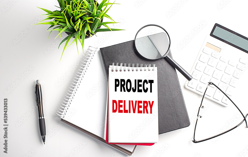 Poster text project delivery on notebook with office tools on white background