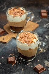 Dessert three chocolates in a jar on a dark background. vertical image. top view. place for text