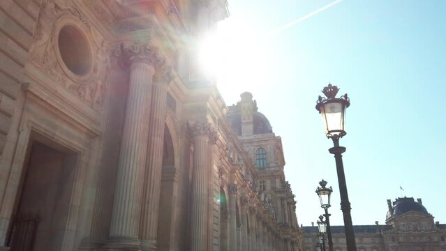 Facade of Louvre museum Paris with sun flare, Paris in France. Low angle