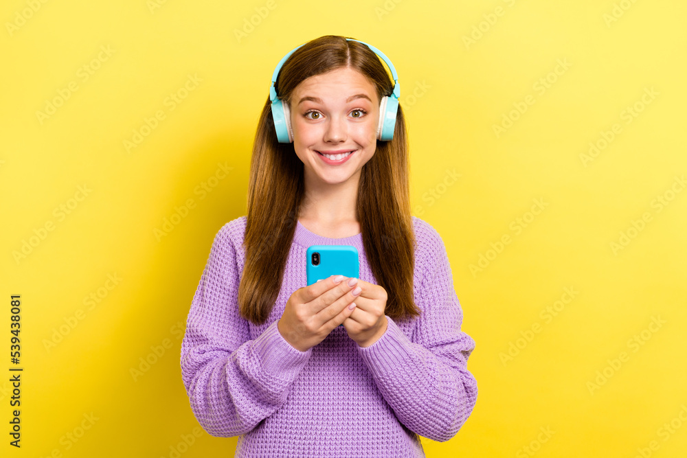 Poster photo of young toothy beaming smiling kid teenager wear new headphones using smartphone bluetooth co