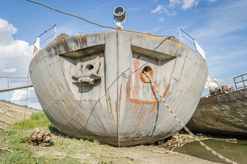A stranded ship on the bank of the Danube river. View of the bow of a stranded ship on the bank of...