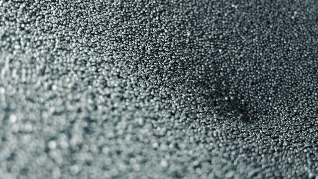 Raw material for production of rubber products. Rubber pellets, close-up, which are automatically fed for remelting.