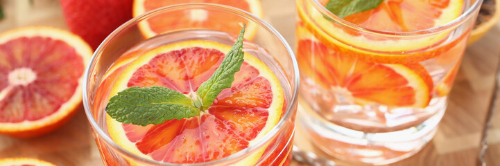 Cooling drinks cocktails in glasses, grapefruit with mint, cheers or toast