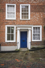 old brick house with blue door