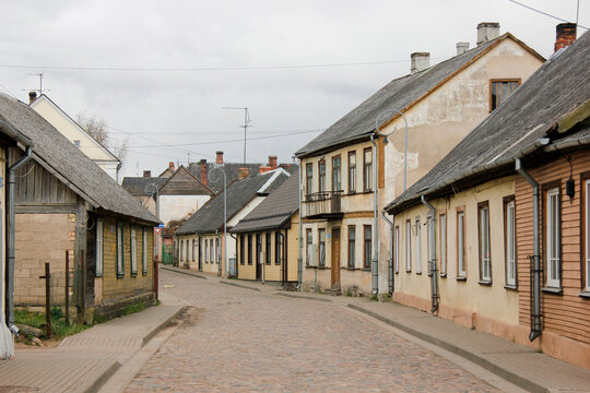 Cobble road street with lots of old wooden buildings. Tukums, Latvia.