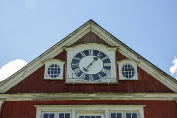 Old, vintage manor house facade in Europe with a large wooden clock