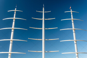 several masts of a yacht without sails