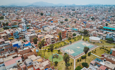 Aerial view of the football field in the middle of a messy neighborhood, Callao, Lima. Peru