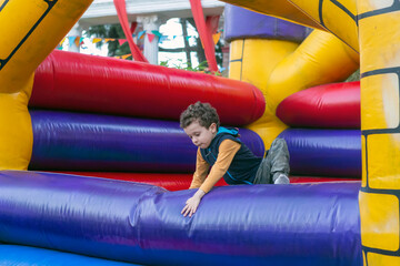 child playing in bouncy castle