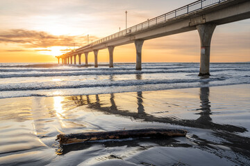 Beautiful sunrise at New Brighton Pier, Christchurch, New Zealand. It is one of eastern country's main entertainment and tourist centers, with its architecturally unique pier and scenic coastline.