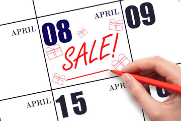 Hand writing text SALE and drawing gift boxes on calendar date April 8. Shopping Reminder