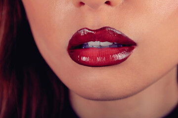 Fototapeta premium woman with glossy red lipstick close up 