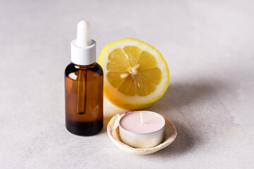 Bottle with Lemon Essential Oil with Lemon Slices Gray Background Cosmetic Citrus Oil or Serum Natural Medicine Concept Aromatherapy Copy Space