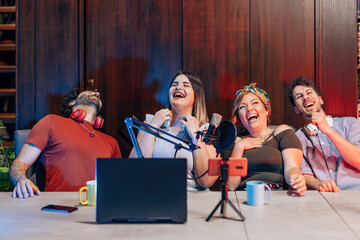 group of digital native friends laughs happy connected streaming on internet blogging channels