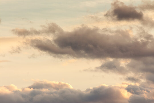 clouds on the sky in golden hour light. warm weather in summer at sunset